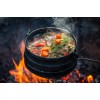 stew cooking in cast iron potjie pot over a campire